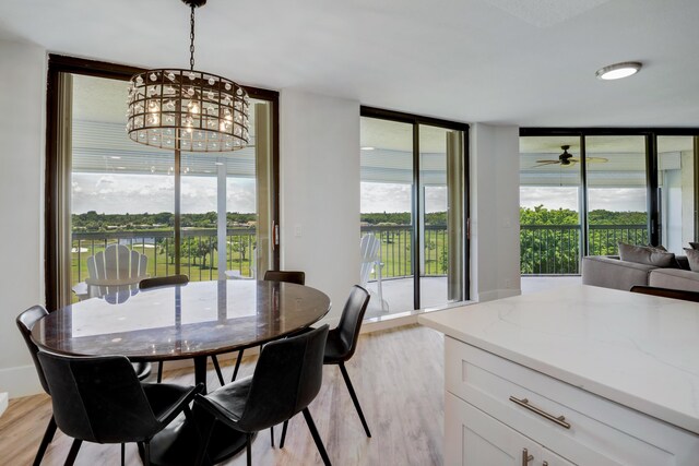 5279 Fountains Dr S Unit 602, Lake Worth, FL 33467 - dining area featuring a chandelier, expansive windows, and light wood finished floors