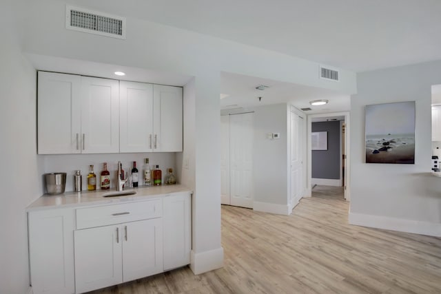 5279 Fountains Dr S Unit 602, Lake Worth, FL 33467 - bar with baseboards, light wood finished floors, a bar, and visible vents