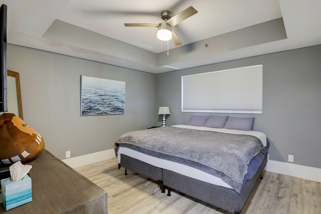 5279 Fountains Dr S Unit 602, Lake Worth, FL 33467 - bedroom featuring baseboards, wood finished floors, and a tray ceiling