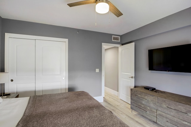 5279 Fountains Dr S Unit 602, Lake Worth, FL 33467 - bedroom with visible vents, light wood-type flooring, a closet, baseboards, and ceiling fan