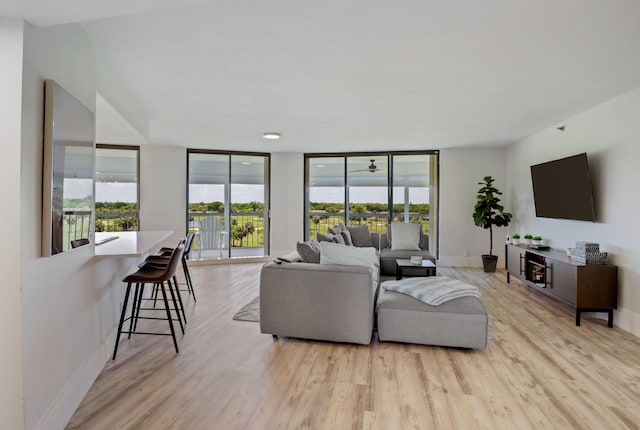 5279 Fountains Dr S Unit 602, Lake Worth, FL 33467 - living area with baseboards, floor to ceiling windows, and light wood-style floors