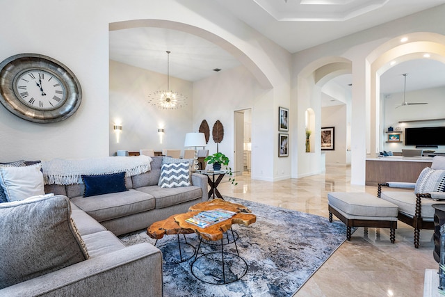 living room with a notable chandelier and a towering ceiling