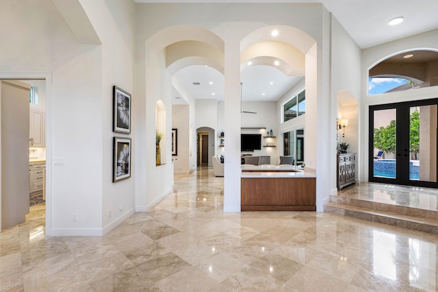 entrance foyer featuring french doors and a towering ceiling