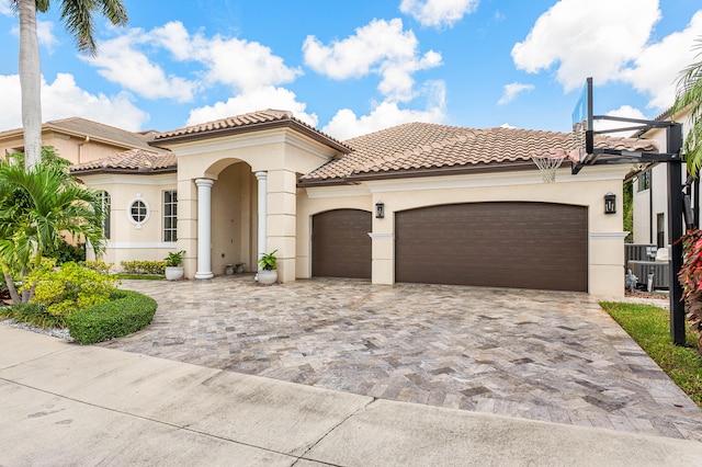 mediterranean / spanish home with a garage