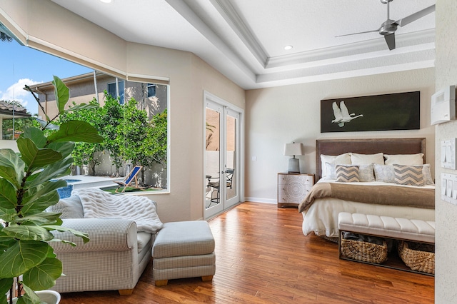 bedroom featuring wood-type flooring, multiple windows, access to outside, and ceiling fan