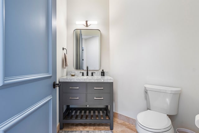 bathroom featuring vanity, toilet, and tile patterned flooring