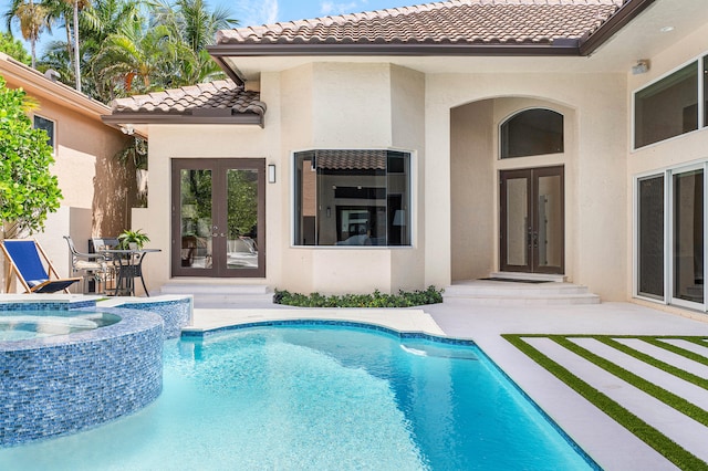 view of pool with french doors and a patio area