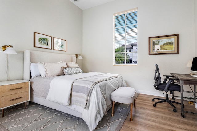 bedroom with hardwood / wood-style flooring