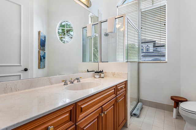 bathroom with toilet, tile patterned flooring, vanity, and a shower with door