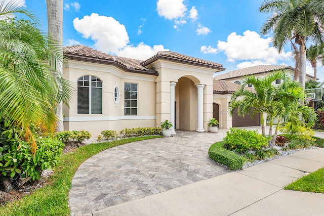 mediterranean / spanish-style home with a garage