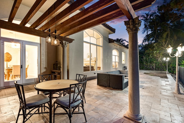 patio terrace at dusk featuring an outdoor living space