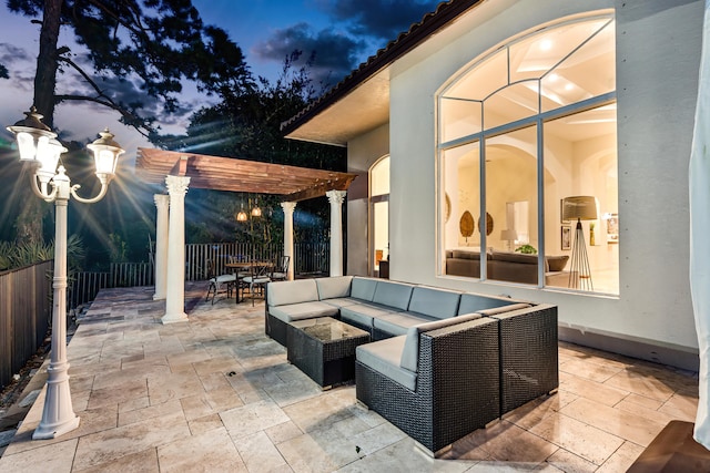 patio terrace at dusk with a pergola and outdoor lounge area