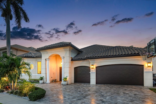 mediterranean / spanish-style home featuring a garage