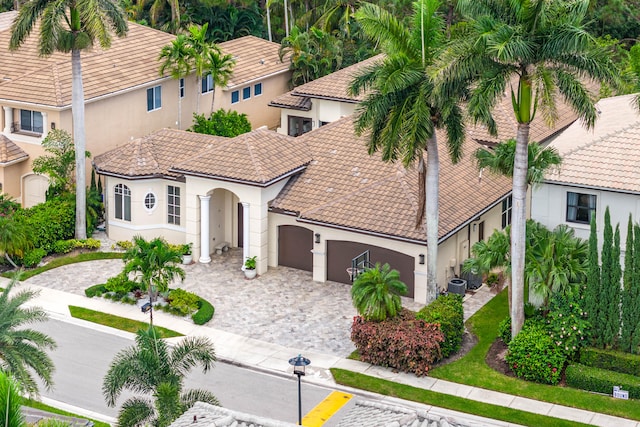 view of front of home featuring central AC and a garage