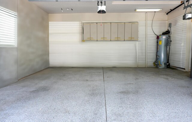 garage featuring gas water heater and a garage door opener