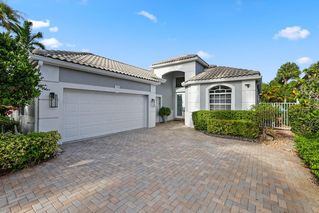 mediterranean / spanish-style home featuring a garage