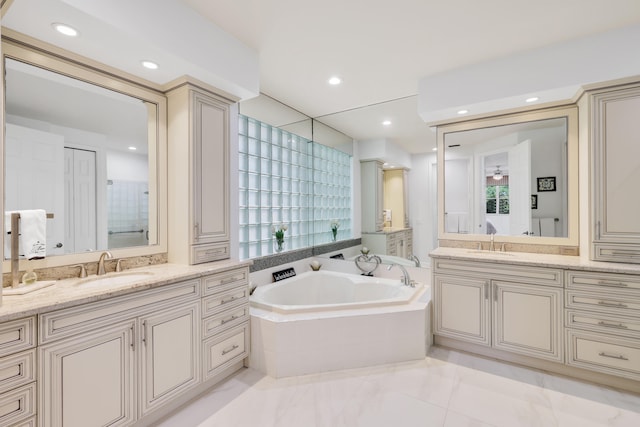 bathroom with vanity and a bathing tub