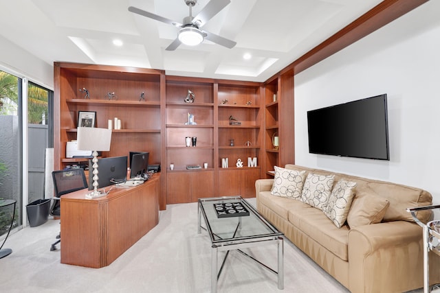 carpeted home office with ceiling fan and coffered ceiling