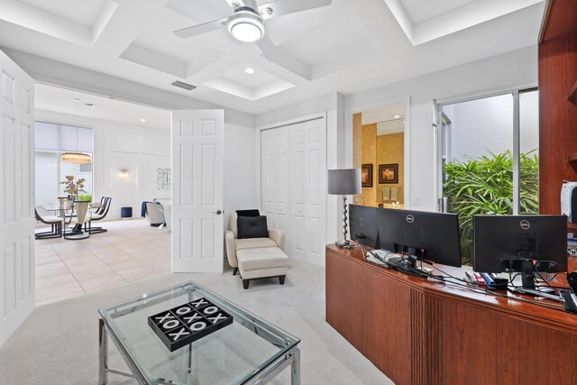 office space featuring coffered ceiling, ceiling fan, light tile patterned floors, and beam ceiling