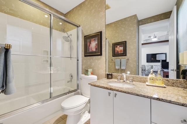 full bathroom with vanity, tile patterned flooring, toilet, enclosed tub / shower combo, and ceiling fan