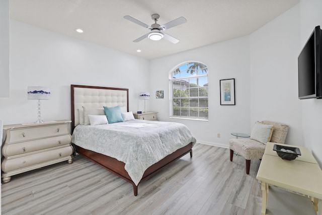 bedroom with ceiling fan and light hardwood / wood-style floors