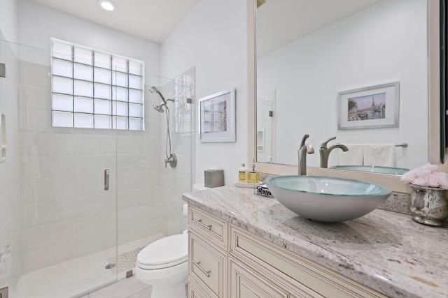 bathroom featuring vanity, toilet, and an enclosed shower