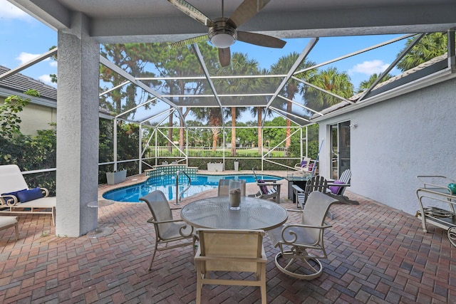 view of pool featuring a lanai, a patio area, and ceiling fan