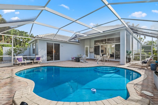 view of pool featuring glass enclosure and a patio