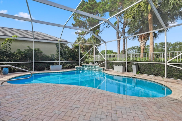 view of pool featuring a patio and glass enclosure