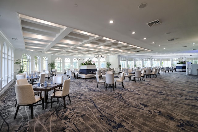 dining space featuring a healthy amount of sunlight and dark colored carpet