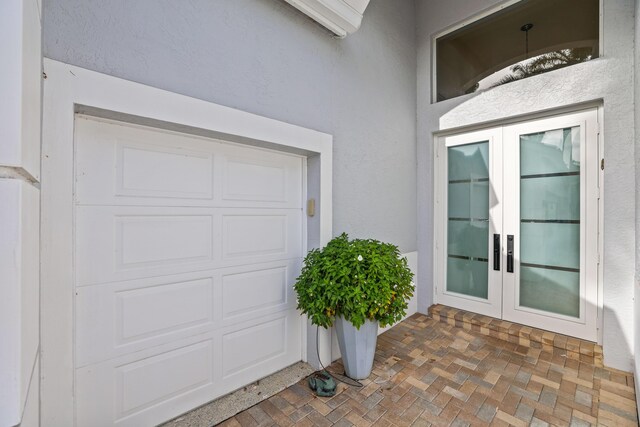 exterior space featuring a garage and french doors