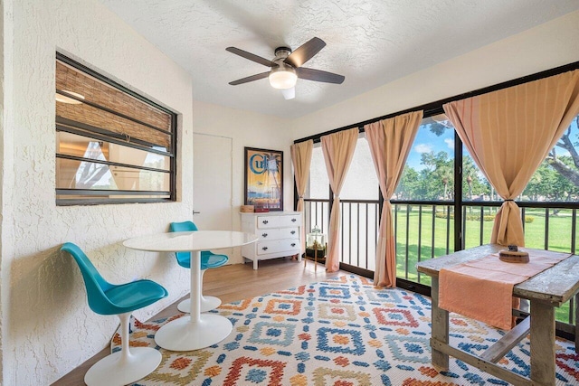 6055 Parkwalk Dr, Boynton Beach, FL 33472 - living area with a textured wall, a ceiling fan, wood finished floors, and a textured ceiling