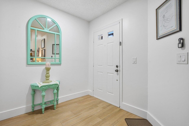 6055 Parkwalk Dr, Boynton Beach, FL 33472 - foyer entrance with wood finished floors, a textured ceiling, and baseboards