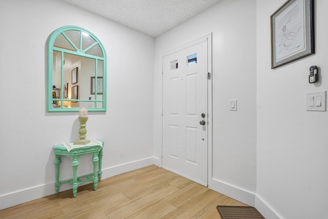 foyer featuring hardwood / wood-style floors and a textured ceiling