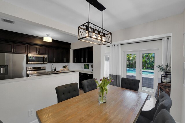 1305 NE 1st Ave, Fort Lauderdale, FL 33304 - dining room featuring a chandelier and french doors