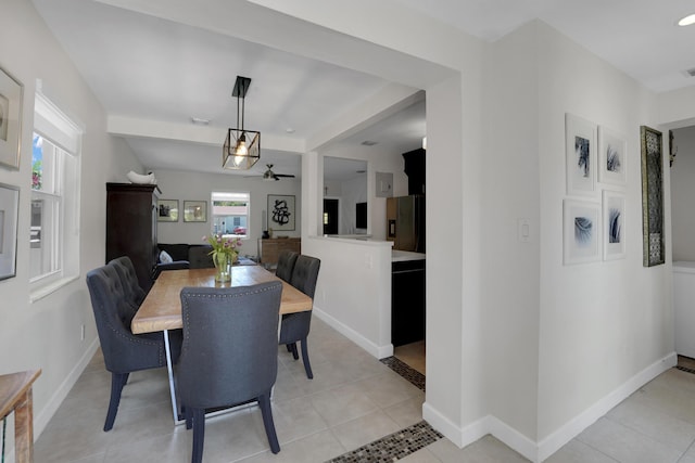 tiled dining room featuring ceiling fan