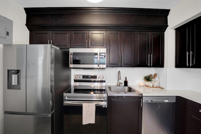 kitchen with tasteful backsplash, dark brown cabinetry, sink, and stainless steel appliances