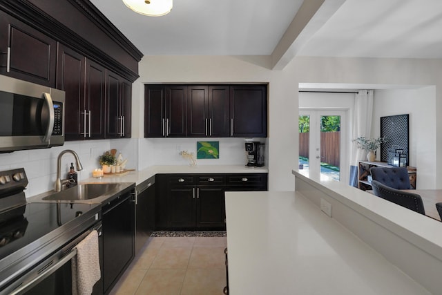 kitchen featuring french doors, sink, stainless steel appliances, dark brown cabinets, and light tile patterned floors