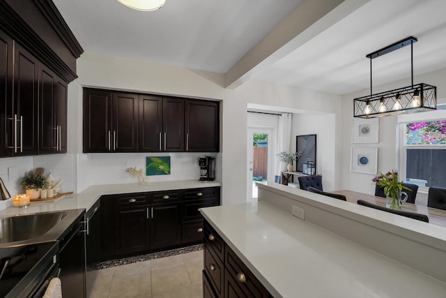 kitchen featuring black electric range, dark brown cabinets, light tile patterned floors, and hanging light fixtures