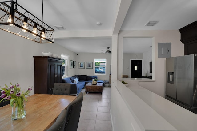 tiled dining area featuring beamed ceiling, electric panel, and ceiling fan