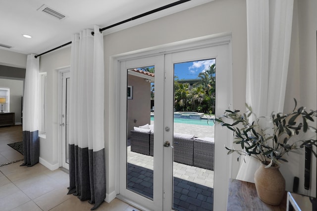 doorway to outside featuring light tile patterned floors and french doors