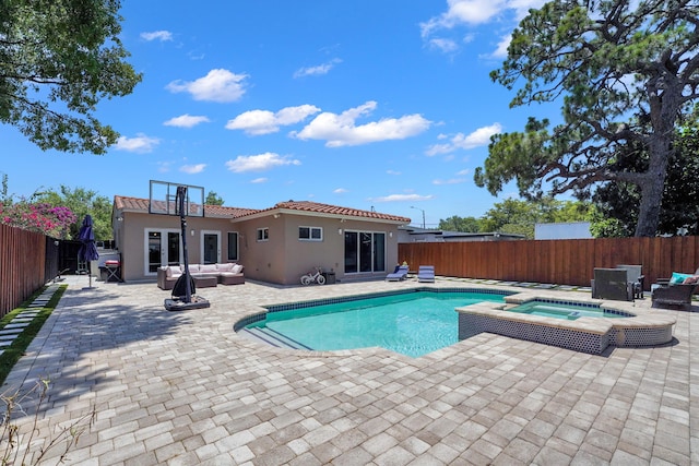 view of pool with a patio area, an outdoor living space, and an in ground hot tub