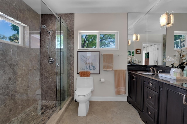 bathroom with tile patterned floors, vanity, toilet, and a shower with shower door