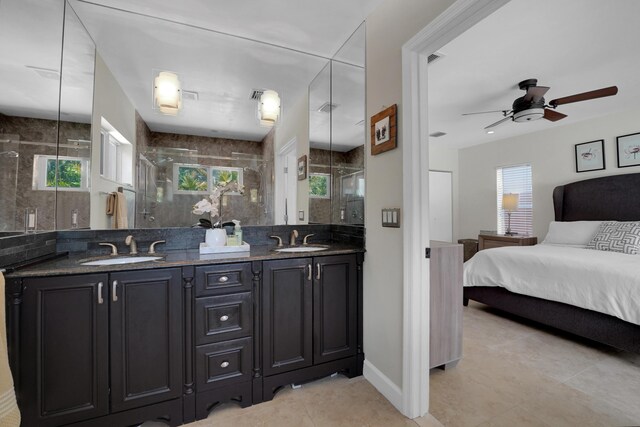 1305 NE 1st Ave, Fort Lauderdale, FL 33304 - bathroom featuring double vanity, ceiling fan, a stall shower, tile patterned floors, and ensuite bath