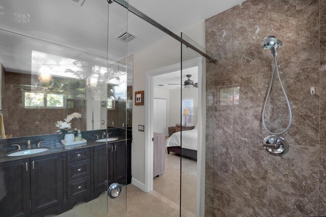 1305 NE 1st Ave, Fort Lauderdale, FL 33304 - bathroom with connected bathroom, a tile shower, double vanity, tile patterned floors, and ceiling fan