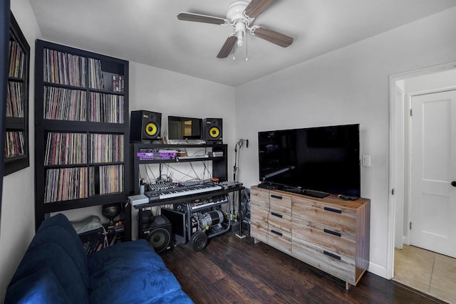 living room with ceiling fan and dark wood-type flooring