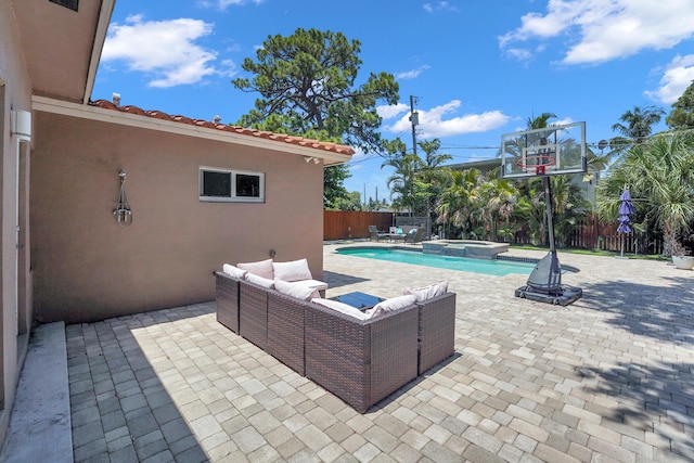 view of patio / terrace featuring a pool with hot tub