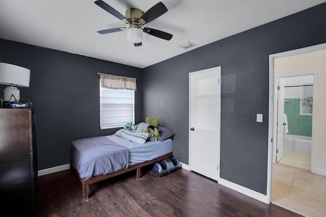 bedroom with dark hardwood / wood-style floors, ceiling fan, and ensuite bathroom