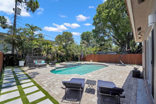 view of swimming pool featuring an in ground hot tub, outdoor lounge area, and a patio area