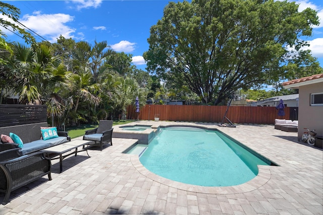 view of swimming pool featuring an in ground hot tub, outdoor lounge area, and a patio area